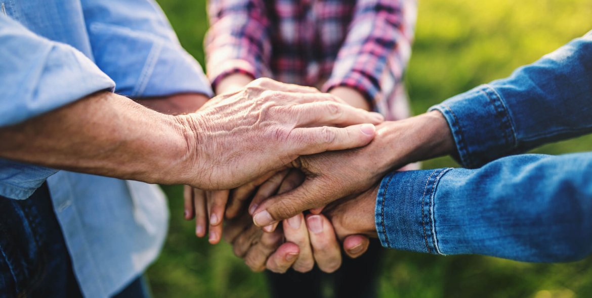 hands-of-small-girl-and-her-senior-grandparents-EKH9UTX.jpg